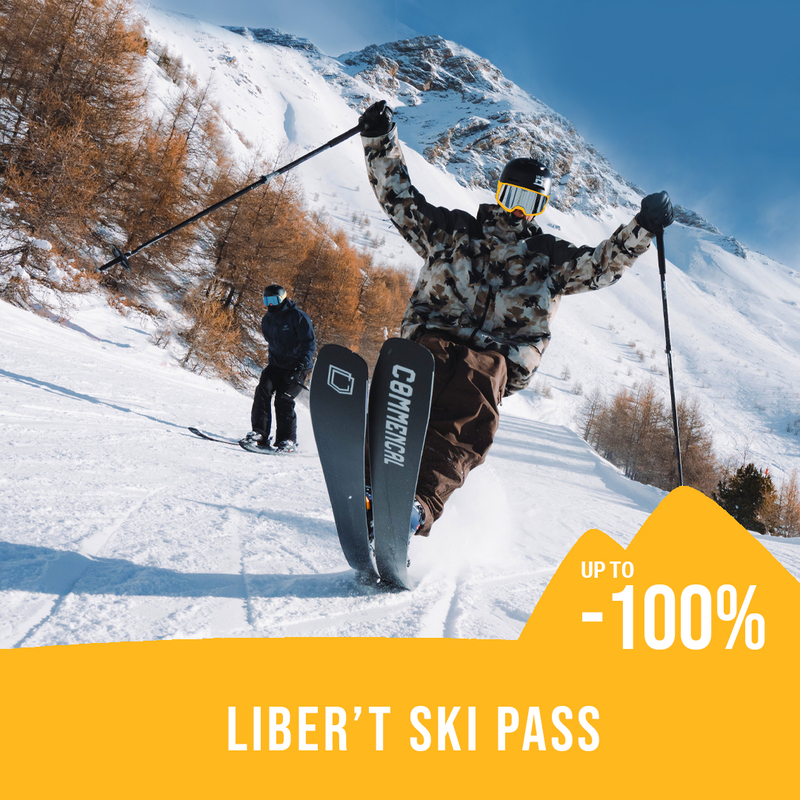 2 skiers on a slope with snowy mountains and larch trees in the background